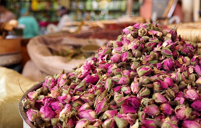 A large pile of dried pink rosebuds in a market setting