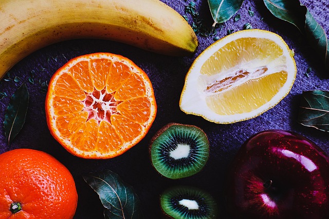 Assorted fresh fruits including a banana, apple, citrus, and kiwi