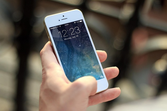 A person holding a smartphone showing the lock screen