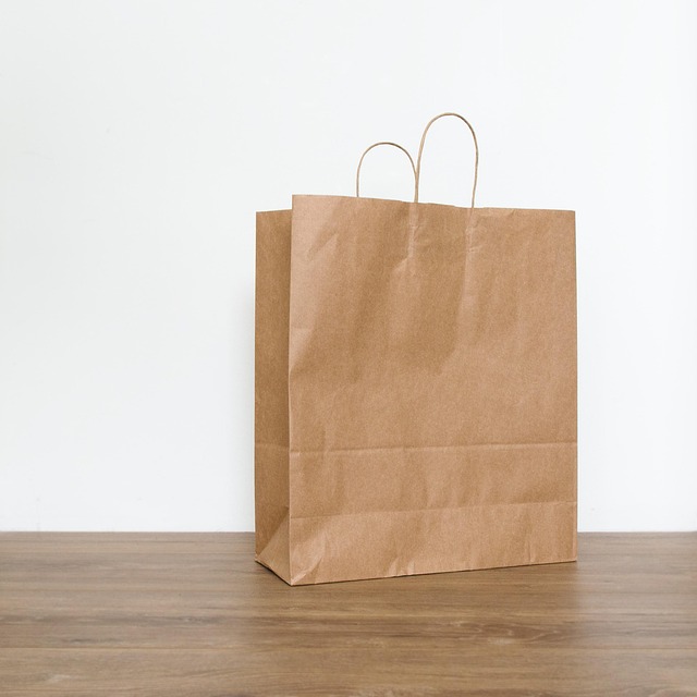 A plain brown paper bag on a wooden surface