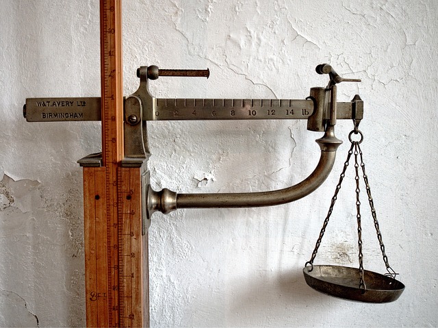 An antique weighing scale with a height measuring rod