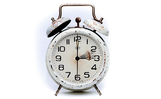 A vintage alarm clock on a plain white background