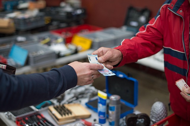 Two people exchanging Euro banknotes in a cash transaction